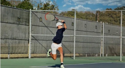 Young tennis player serving